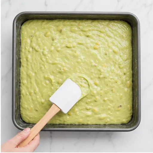 Step 2: Pouring the batter into a greased 9x13 pan and spreading it evenly