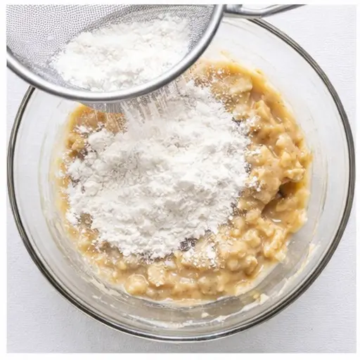 Step 3: Sifting dry ingredients over the wet batter