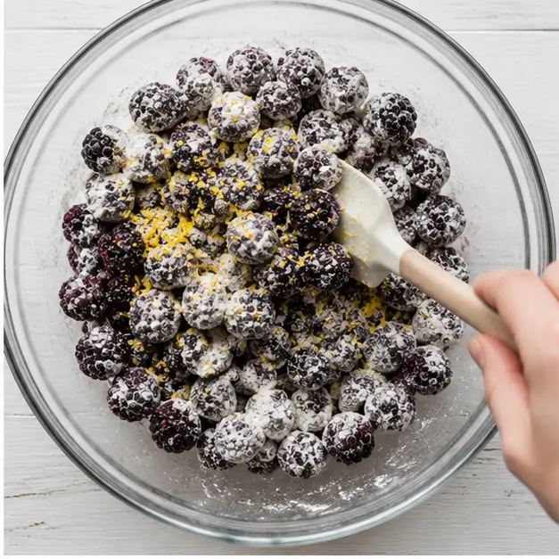 Step 2: Tossing blackberries with dry ingredients and lemon