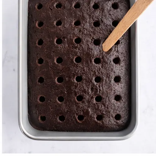 Step 2: Poking holes with a wooden spoon