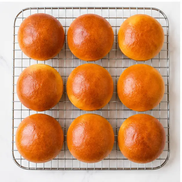 Step 3: Baked golden brown brioche buns cooling on a wire rack