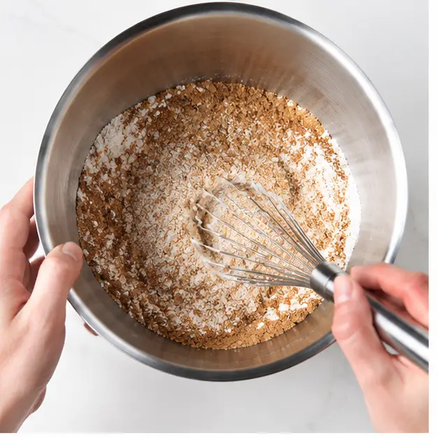 Step 1: Whisking graham cracker crumbs into dry ingredients