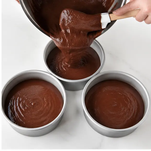 Step 2: Pouring batter into prepared cake pans