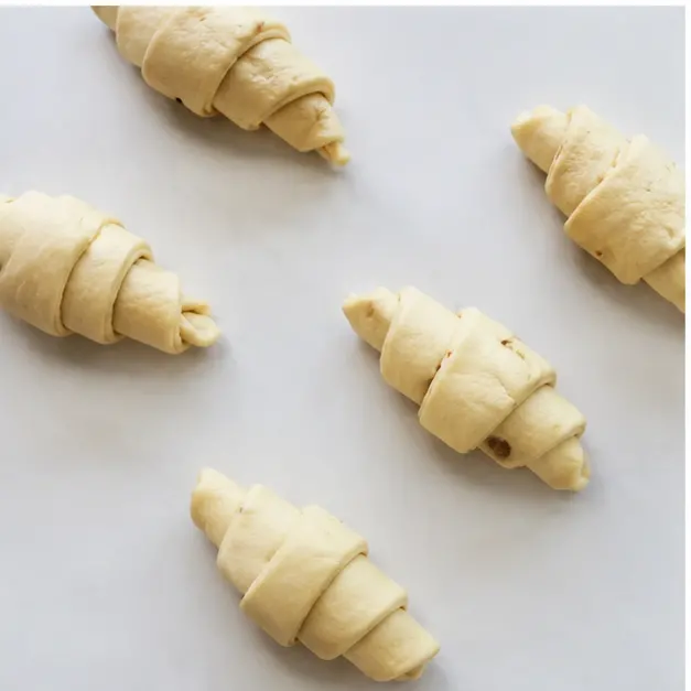 Step 3: Rolling dough triangles into crescent shapes