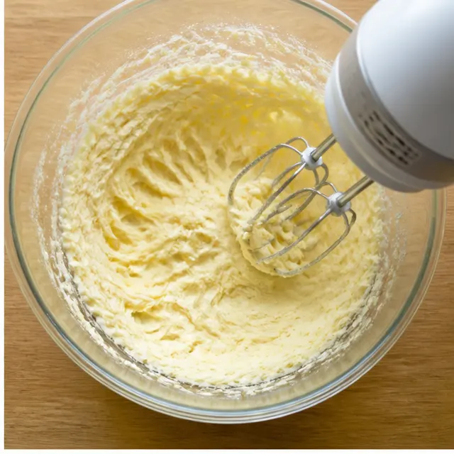 Creaming softened butter with sugar until light and fluffy for the muffin batter
