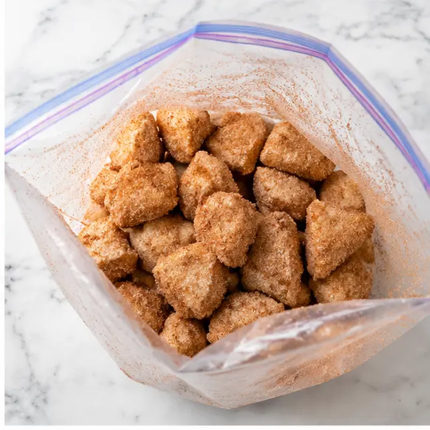 Shake biscuit pieces in cinnamon sugar coating