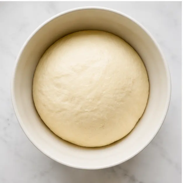 Step 3: Let the dough rise until doubled, then shape it into 8 smooth round balls