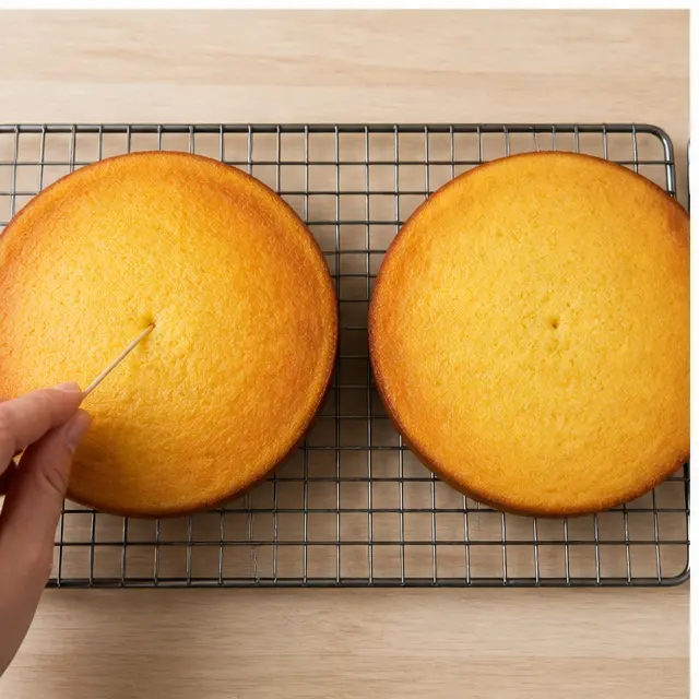 Step 2: Dividing batter evenly between two prepared cake pans