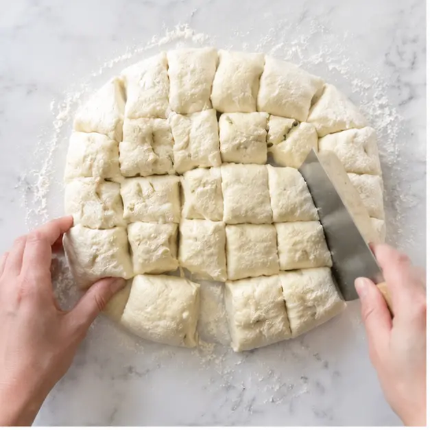 Cut rested dough into 36 rough pieces on a floured surface