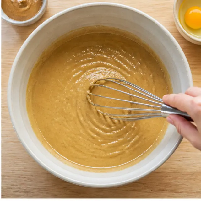 Whisking the glossy wet batter of banana, almond butter, egg, and vanilla until smooth