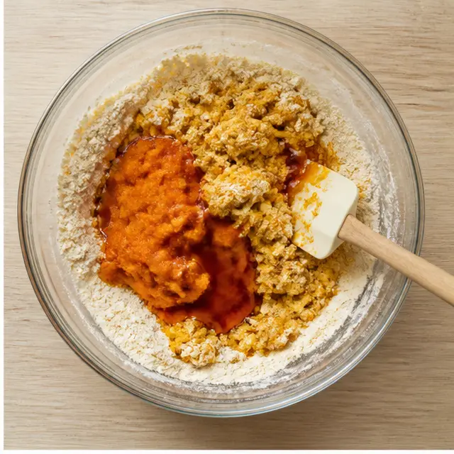 Add pumpkin puree and maple syrup to form a shaggy dough