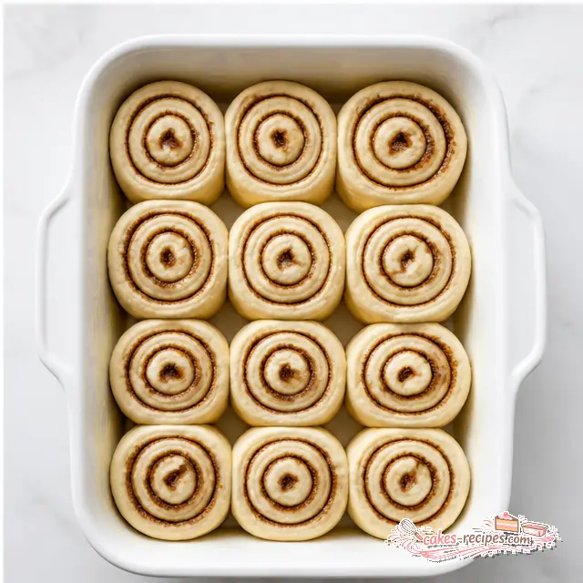 Step 4: Arranging the sliced rolls in a white ceramic baking dish