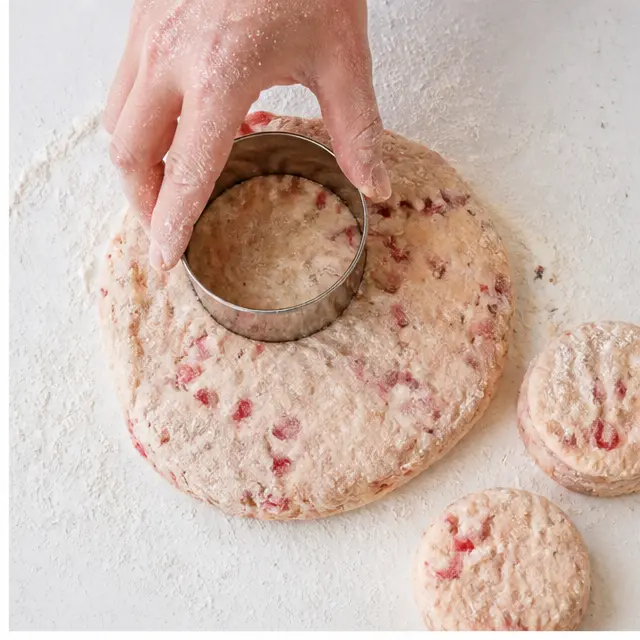 Step 2: Pressing a floured biscuit cutter straight down into the dough