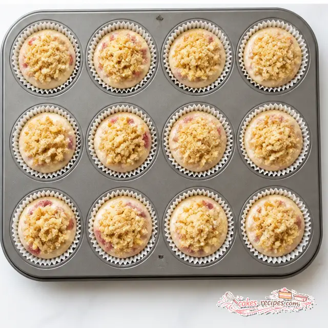 Filling muffin cups and sprinkling streusel over top