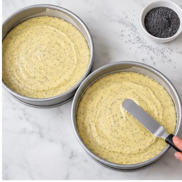 Step 2: Divide the smooth poppy seed batter between two parchment-lined 8-inch round pans