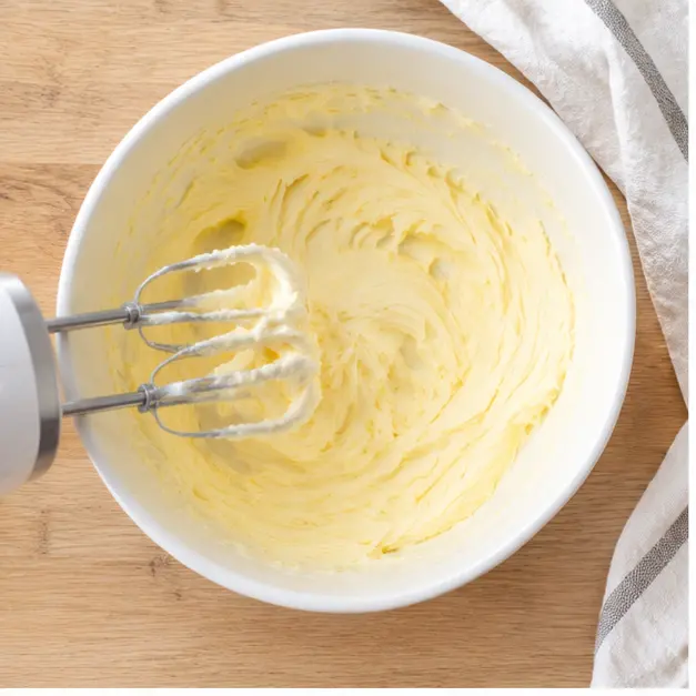 Step 1: beating soft pale unsalted butter smooth in a white ceramic bowl until lightened in color
